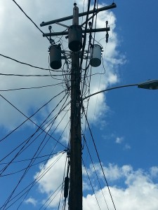 A tangle of wires feeding shotgun houses