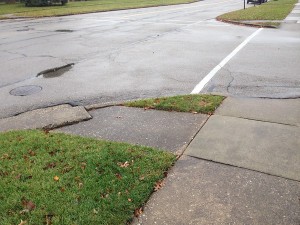 Sidewalks cross at intersections, providing separate crossings for each travel direction.