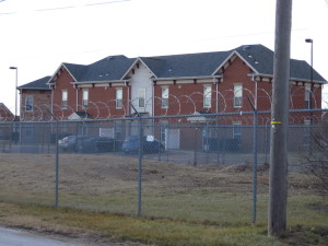 Apartments located across an industrial property protected by razor wire.