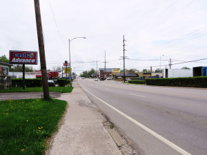 Sidewalk along this section of Versailles has little elevation separation from the street.
